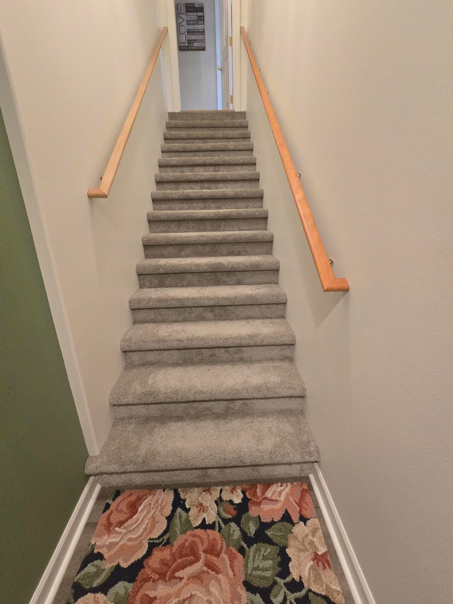 Carpeted stairway before renovation
